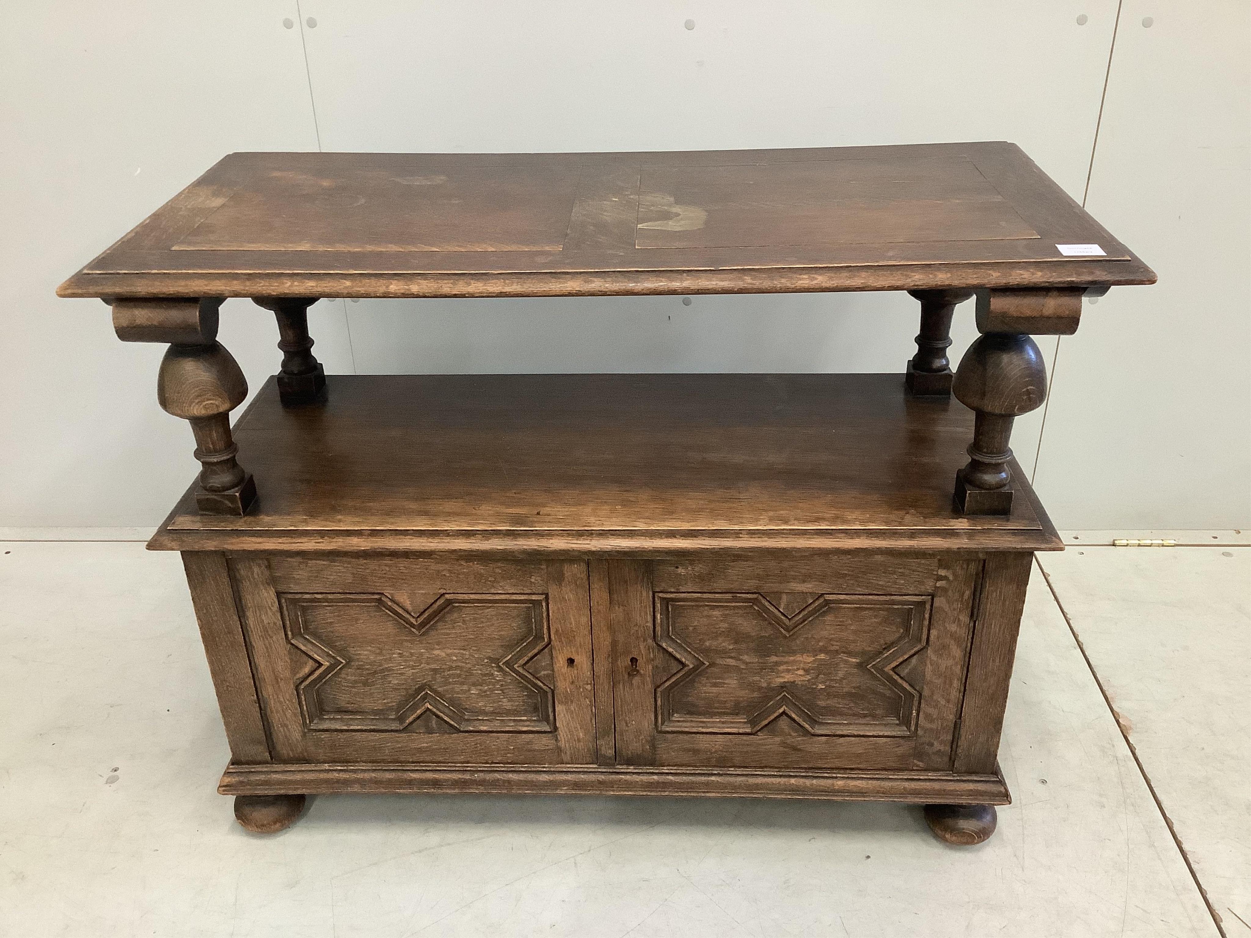 A 1920's oak monk's bench, width 107cm, depth 48cm, height 100cm. Condition - fair